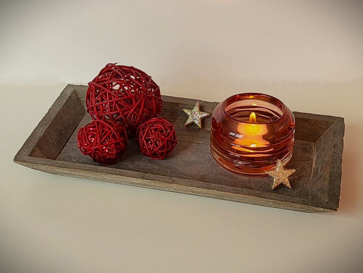 Teelichthalter Glas mit einer gewellten Struktur rötlich gefärbt, aber durchsichtig.